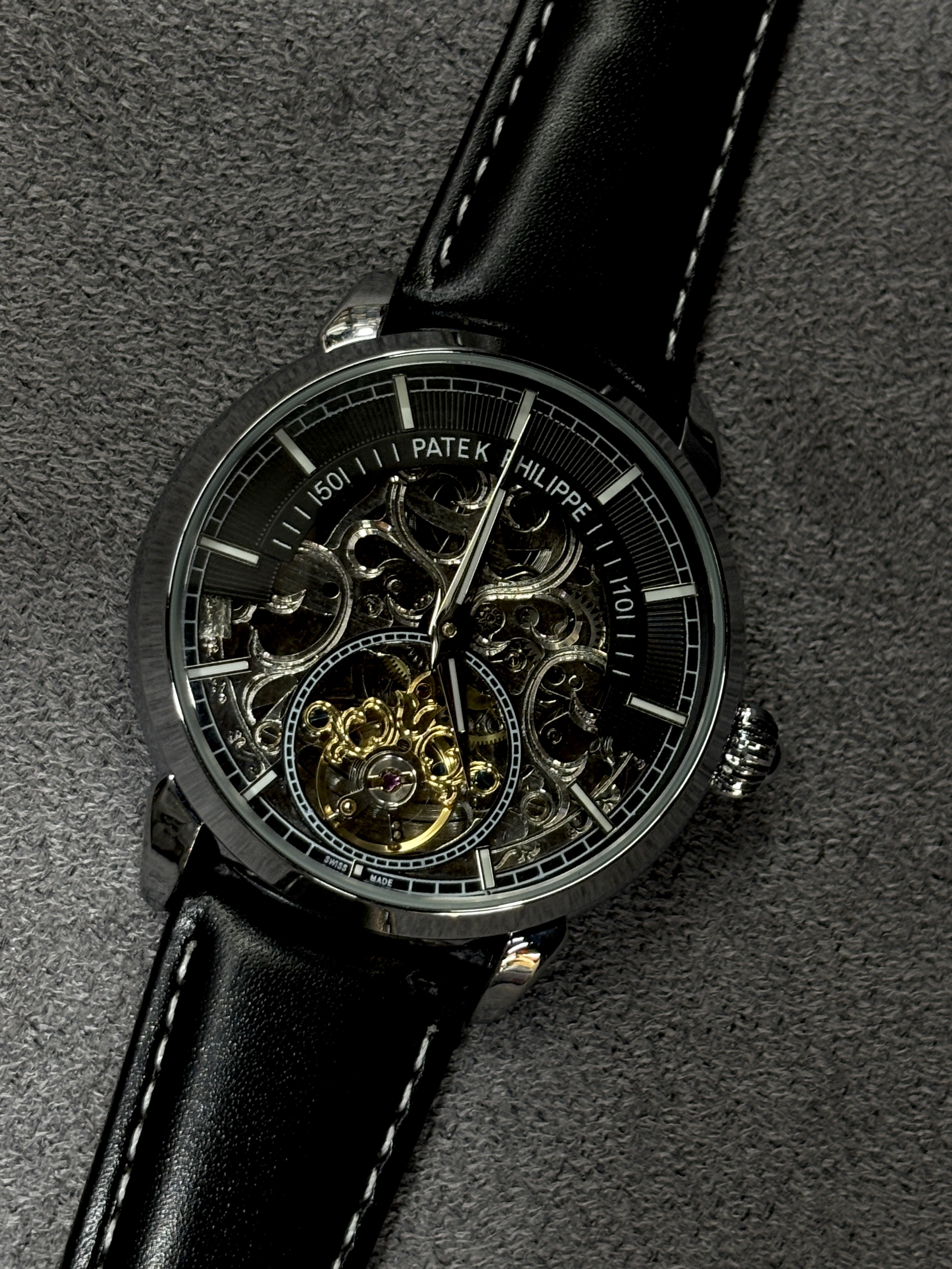 AAA(copy) Patek Philippe skeleton watch with a black leather strap.