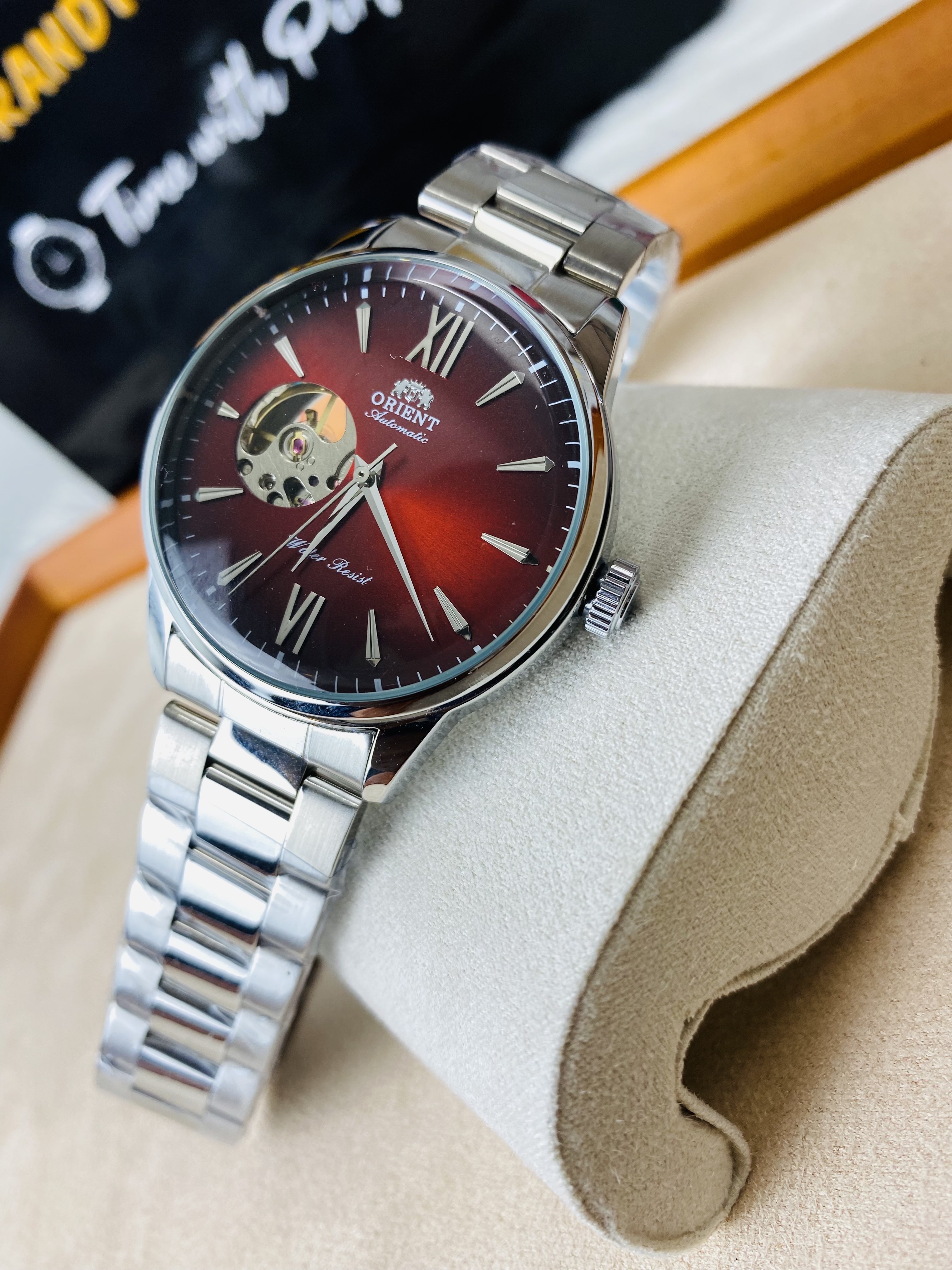 Orient Bambino Open Heart automatic men's watch with a red dial and a stainless steel bracelet._img_1