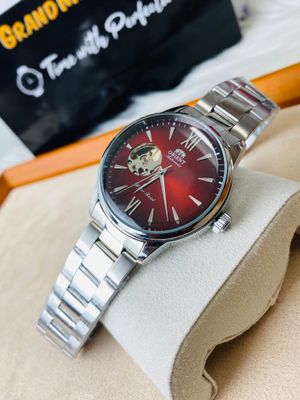 Orient Bambino Open Heart automatic men's watch with a red dial and a stainless steel bracelet._img_0
