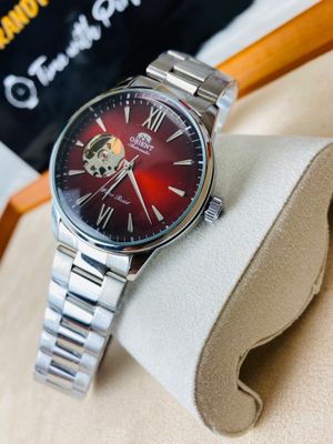 Orient Bambino Open Heart automatic men's watch with a red dial and a stainless steel bracelet._img_1