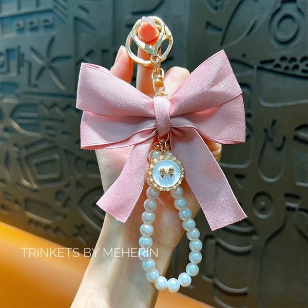 Baby pink bow pearl charm