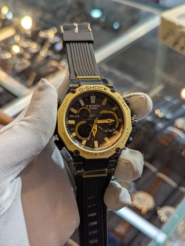 G shock bulky black belt gold bezel gold dot